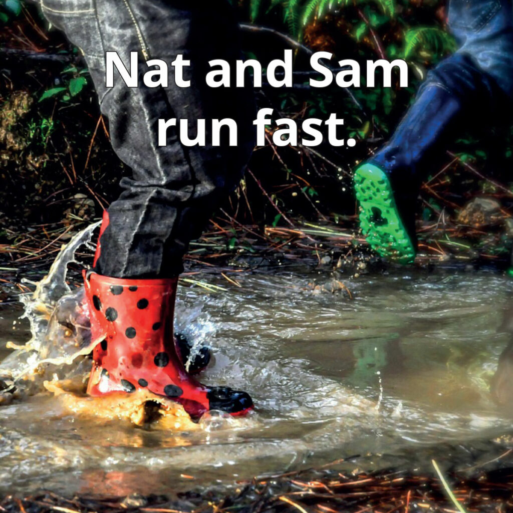 Mud reader image of children wearing brightly colored boots through puddles