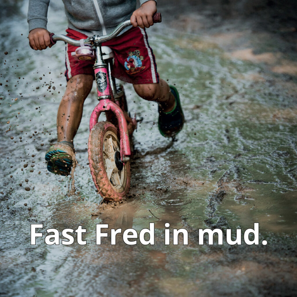 Mud reader image child riding bike through mud puddle