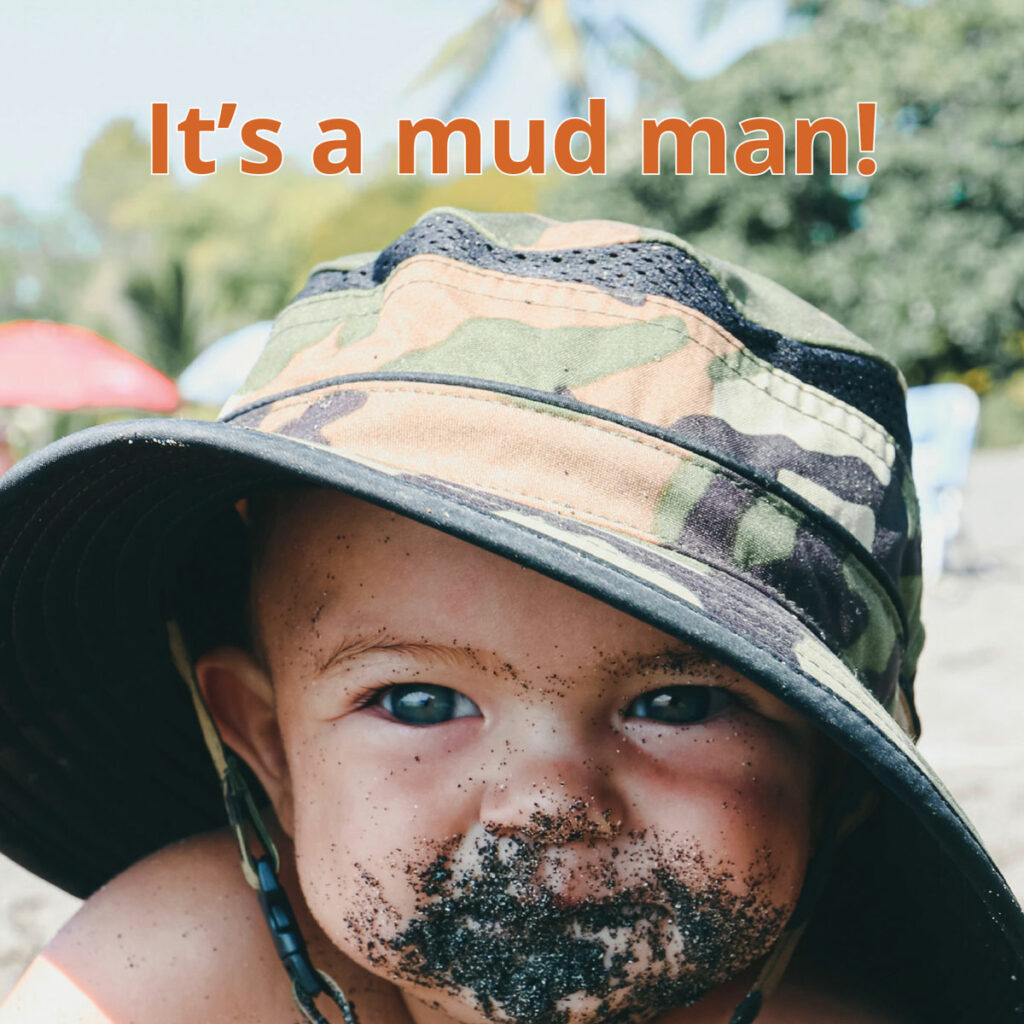 Mud reader image of small child in hat with mud on his face