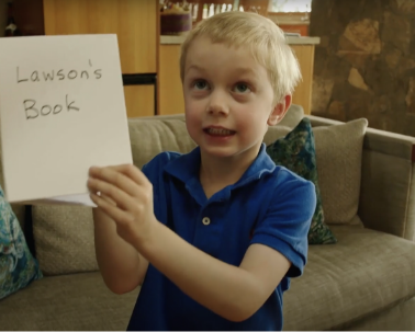 Boy holding up a hand-made book