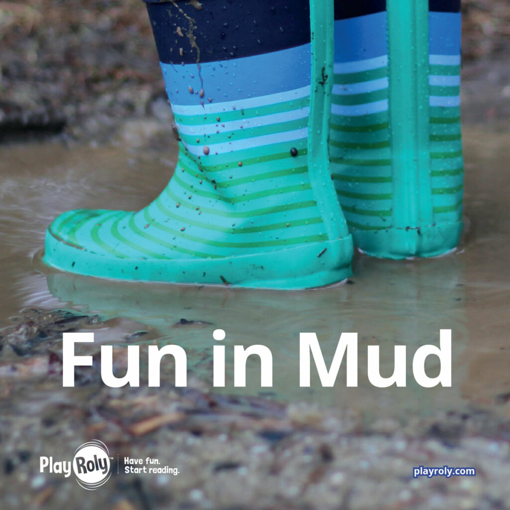Mud reader image child's blue and green boots in mud puddle